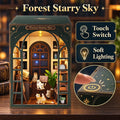 A decorative miniature house labeled 'Forest Starry Sky' shown on a wooden surface with warm interior lighting. The box-style dollhouse features a dark green exterior, arched window frame, bookshelves, stars, and small cat figurines inside.